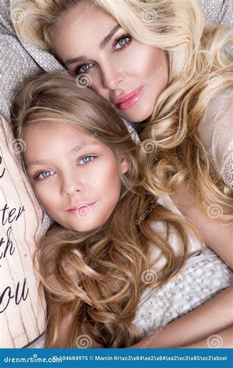 Portrait Of The Beautiful Blonde Woman Mother And Daughter On The Beautiful Face And Amazing