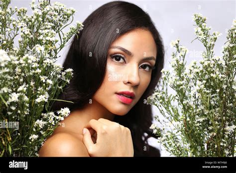 Amazing Brunette With White Flowers On The Studio Background The Concept Of Beauty And Health