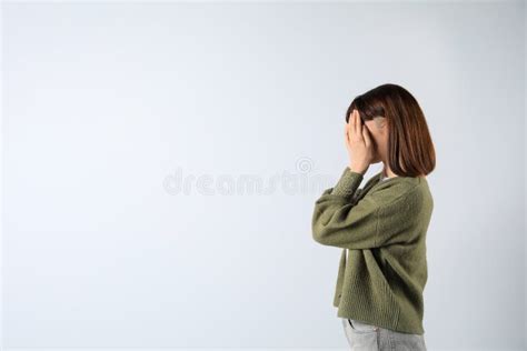 Young Girl Hiding Face in Hands on White Background. Space for Text ...