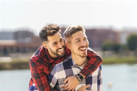 Tiro médio de um casal gay abraçando e rindo Foto Premium