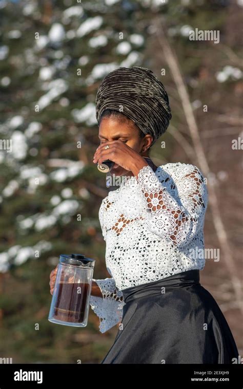 Beautiful Girl Walking And Drinking Hot Coffee Or Tea On The Snow On A Frozen Lake In Winter
