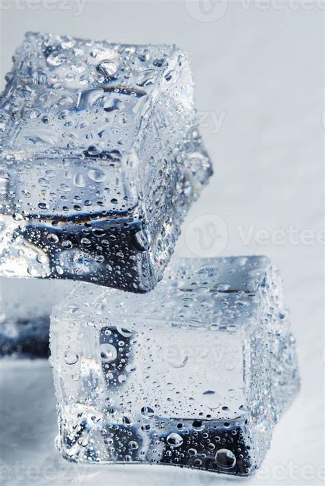 Ice Cube With Water Drops Close Up In Macro On A White Background