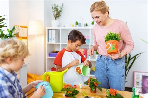 Premium Photo Painting Time Blonde Haired Beaming Ecology Teacher Watching Her Cute Pupils