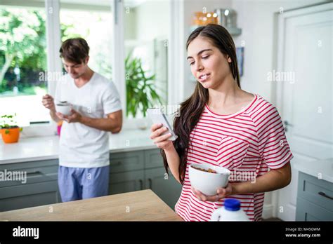 Smiling Brunette Using Smartphone During Breakfast Stock Photo Alamy