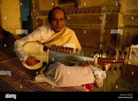 Man playing sarod hi-res stock photography and images - Alamy