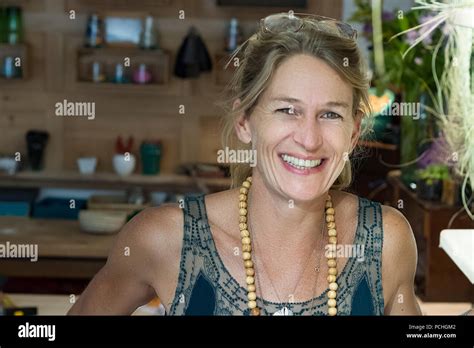 Portrait Of French Blonde Mature Woman Smiling In Her Handmade Gifts Store In France