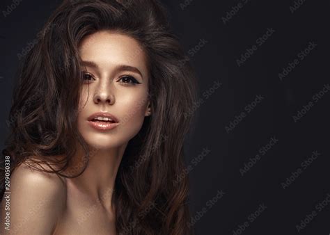 Beautiful Brunette Model With Volume Curls Classic Makeup And Sexy Lips The Beauty Of The Face
