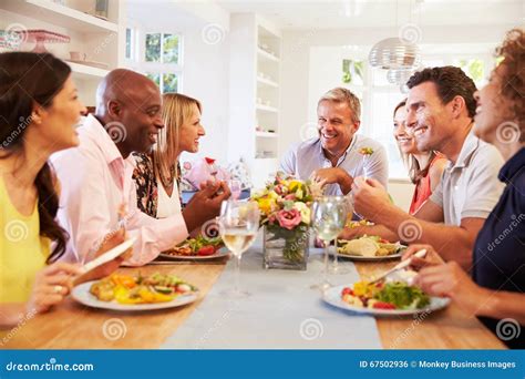 Mature Friends Sitting Around Table At Dinner Party Stock Photo Image