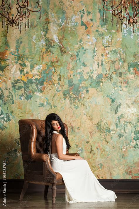 Attractive Brunette Woman In Vintage Interior Beautiful Female Model On Green Stucco Wall