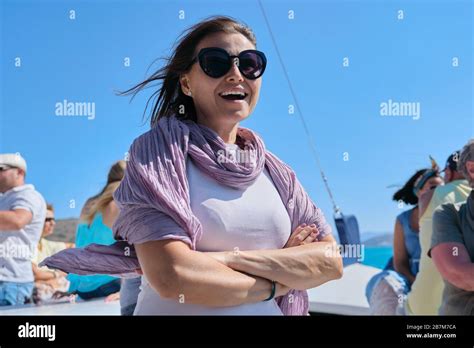 Boat Trip On Small Ship On Bay Mature Female With Group Of Tourists Enjoying Sea Voyage Sunny