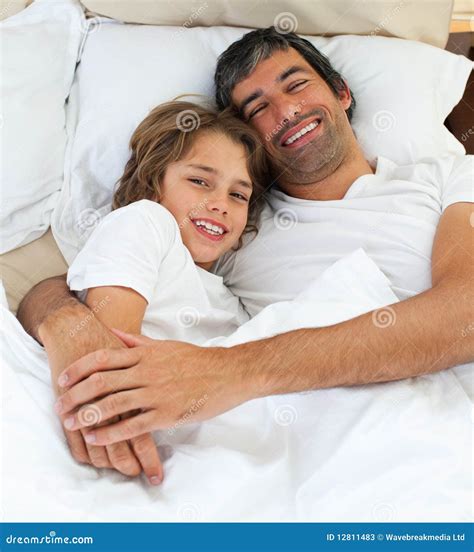 Loving Father Hugging His Son Lying On The Bed Stock Image Image Of