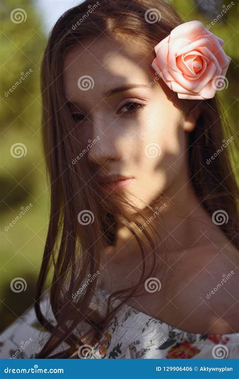 Portrait Of Mysterious Brunette With Rays Of Sunshine Falling Onto Her Beauty Face Stock Photo