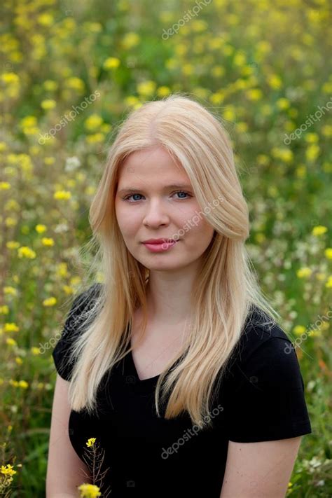 Beautiful Blonde Girl Surrounded By Flowers Stock Photo Gelpi