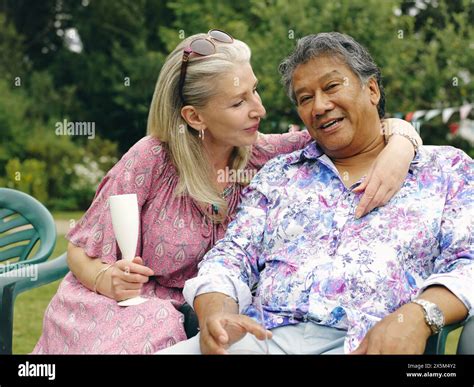 Mature Couple Embracing In Backyard Stock Photo Alamy