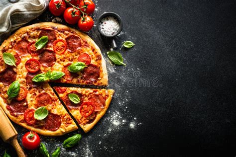 Traditional Italian Pizza With Salami Cheese Tomatoes And Basil Stock