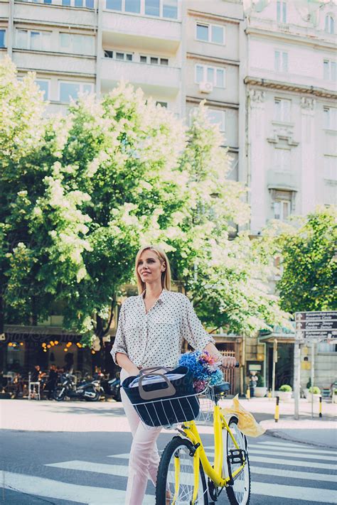 "Woman Pushing A Bike" by Stocksy Contributor "Lumina" - Stocksy