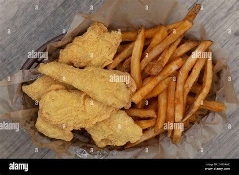 Overhead View Of Tempting Basket Of Crispy Breaded Fish Sticks And A