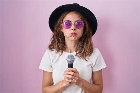 Beautiful Brunette Woman Singing Song Using Microphone Puffing Cheeks With Funny Face Stock