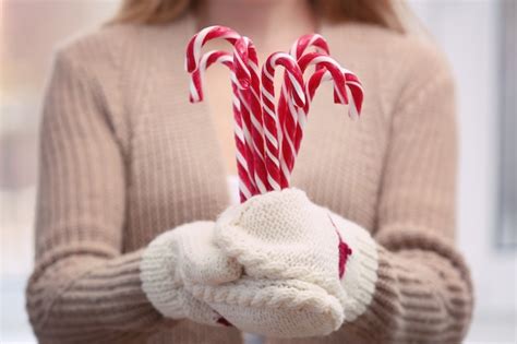 Premium Photo Woman Holding Candy Canes Closeup