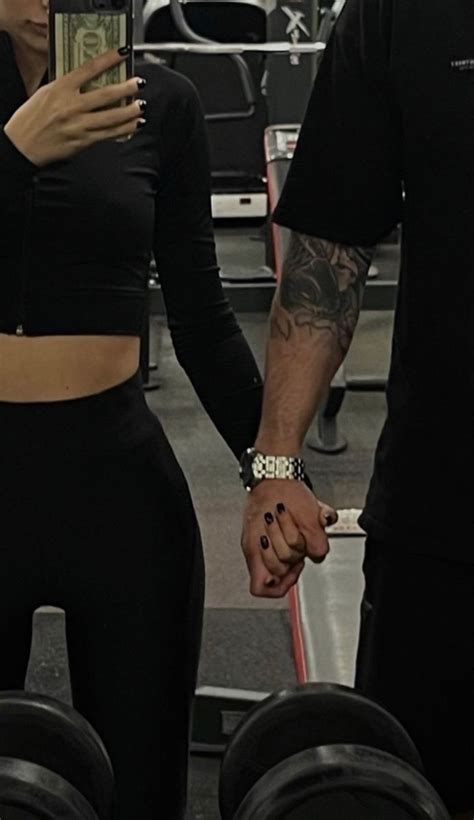 A Man And Woman Holding Hands In A Gym