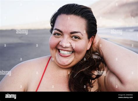 Portrait Of Plus Size Woman Smiling On Camera Wearing Bikini At The Beach Focus On Face Stock