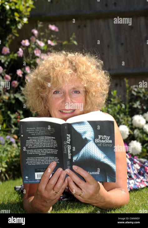 Mature Woman In S Reading Sexy Erotic Novel Fifty Shades Of Grey By E L James While Sitting In