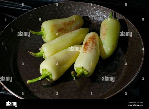 Frying A Group Of Yellow Hot Peppers On A Pan With Oil Macro Photography Or Close Up Image Stock