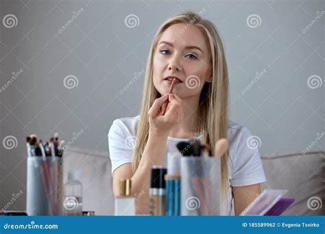 Bright Beautiful Blonde With Bright Lips Puts Lipstick On The Lips Stock Photo Image Of Apply