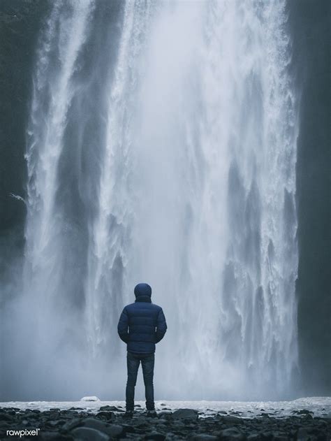 Man enjoying a view of Skógafoss waterfall in Iceland | free image by rawpixel.com | Skogafoss ...