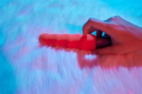 Premium Photo Desire Concept Woman Lying In Bed Holding A Dildo Vibrator In Her Hand To Help