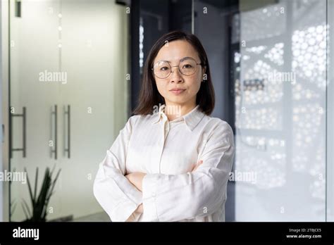 Portrait Of Mature Experienced Asian Businesswoman Boss Female Worker Looking At Camera