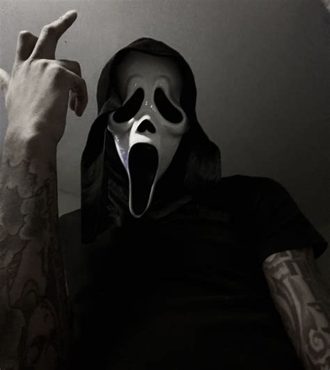 A Man Wearing A Mask And Pointing His Finger At The Camera