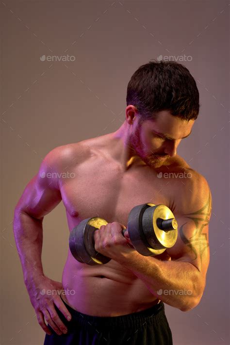 Strong Bodybuilder With Naked Upper Body Standing With Dumbbell Stock Photo By Albertshakirov