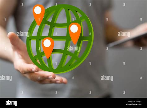 A Green Globe Showing Locations Around The World Above A Mans Hand