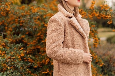 Woman In A Nude Soft Coat Posing Near A Colourful Bush In Nature Autumn Mockup Stock Photo By