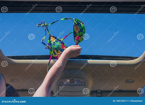 Girl Trowing Away Her Bikini Bra Out From Open Hatch Of A Vehicle