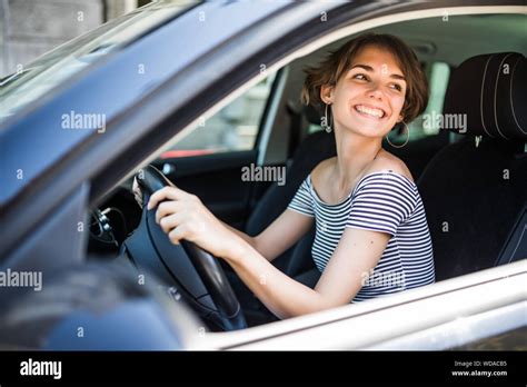 Smiling Beautiful Brunette Woman Driving A Car Stock Photo Alamy