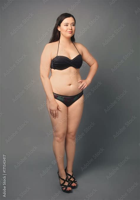 Beautiful Overweight Woman In Black Bikini On Grey Background Stock