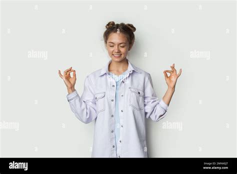 Calm Brunette Woman With Closed Eyes And Smiling Peacefully Meditating With Hands Spread
