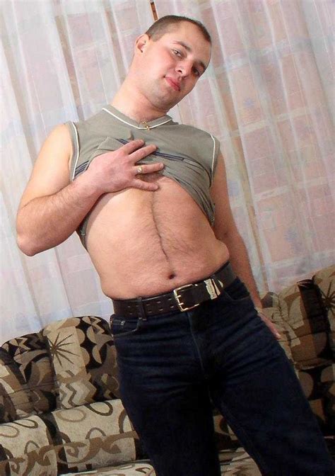 Horny Naked Gay Bear Enjoys Teasing And Posing On A Sofa Porn Pictures