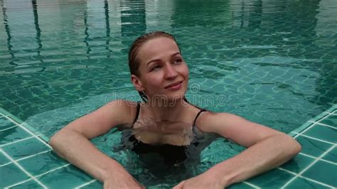 Beautiful Happy Slim Woman In A Black Bikini Smiling And Relaxing In Hotel Pool Stock Video