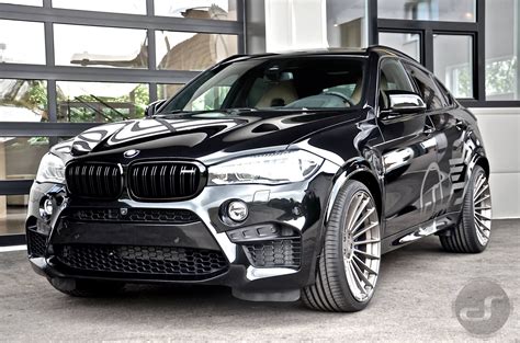 Vintage Black BMW SUV Parked in Front of a Garage