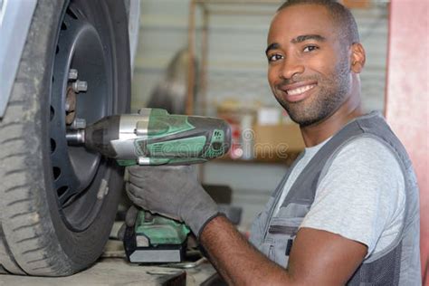 man unbolting rim bolts stock photo image  vulcanizing