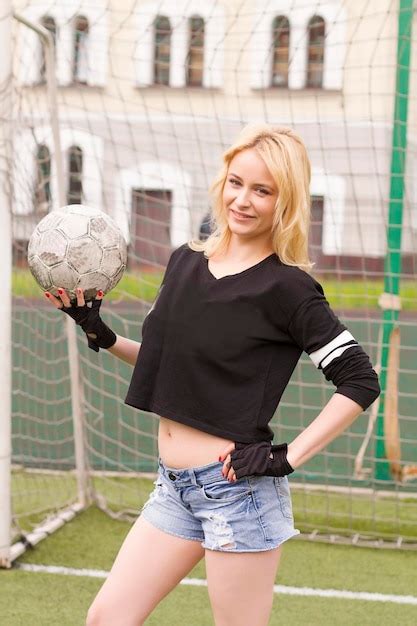 Premium Photo Beautiful Blonde With A Ball At The Football Goal