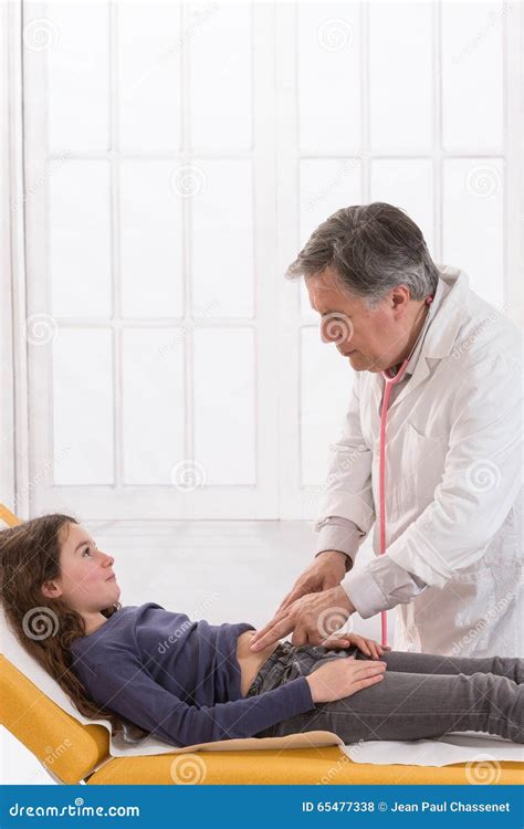 Mature Doctor Touches Belly Of Teenager Patient In Stock Photo Image Of Palpates Female