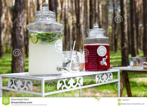 Glass Jars With Fresh Lemonade And Snacks On Wooden Tables Wedd Stock