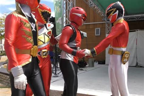 Two Men In Red And White Costumes Standing Next To Each Other With