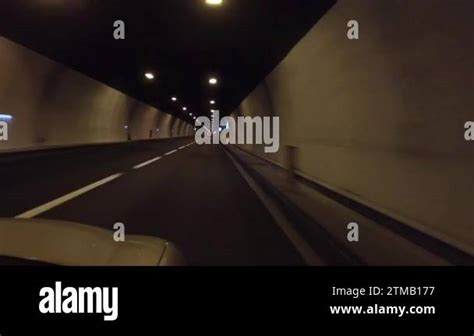 Driving car in dark tunnel highway under mountains 4k POV. Riding car ...