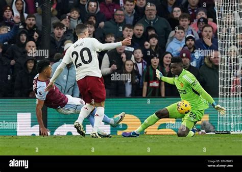 Manchester United goalkeeper Andre Onana (right) makes a save from ...