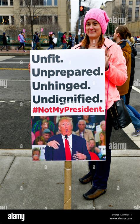 Woman Wearing Pink Pussy Hat Holds Sign Reading Unfit Unprepared Unhinged Undignified Not My